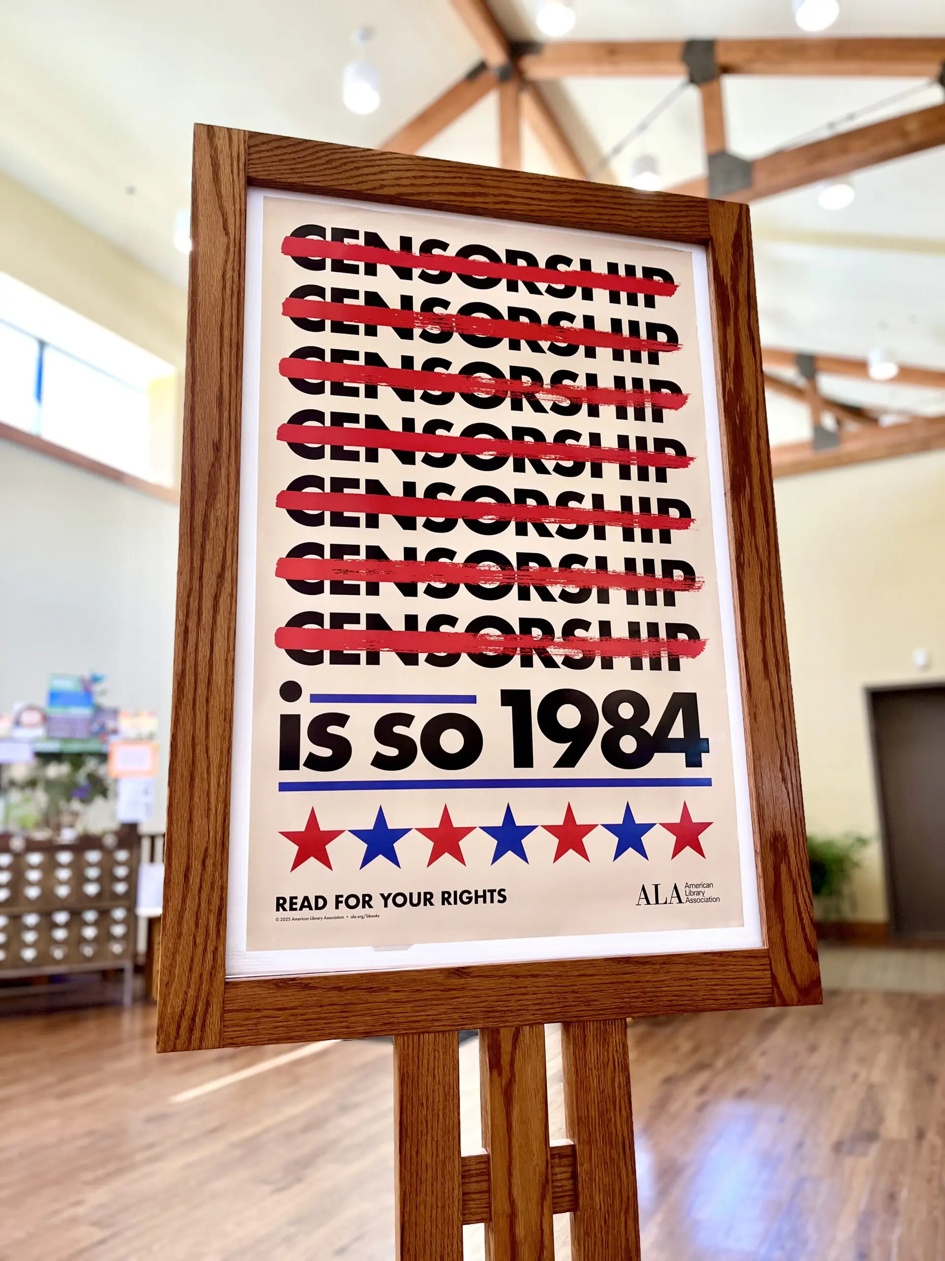 large white poster with the repeating word CENSORSHIP crossed out in red that reads "Censorship is so 1984. Read for your rights"