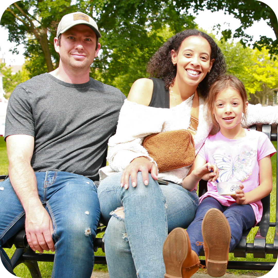 millage taxpayers image of family sitting in a park and smiling on a sunny day